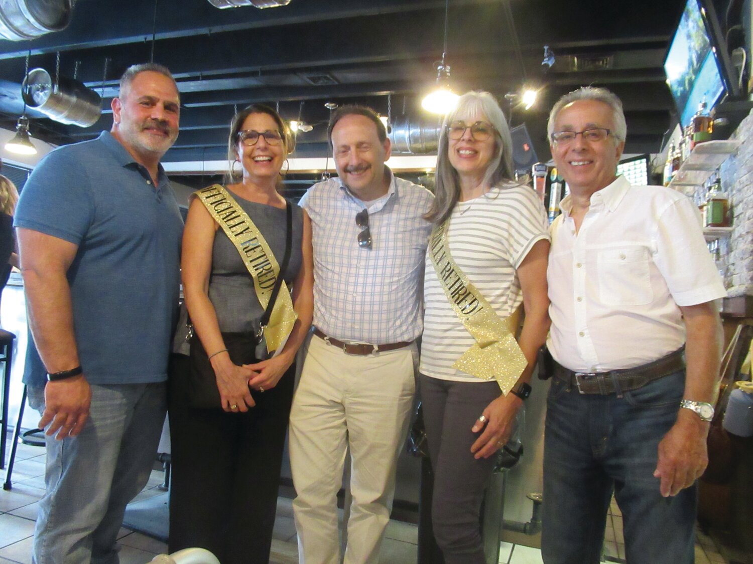 SPECIAL SENDOFF: Julie-anne Zarrella and Brenda Lee Troia are all smiles and joined by Johnston School Committee Vice Chairman Joe Rotella, Superintendent of Schools Dr. Bernard DiLullo Jr. and School Committee Chairman Bob LaFazia during last Wednesday’s retirement party.